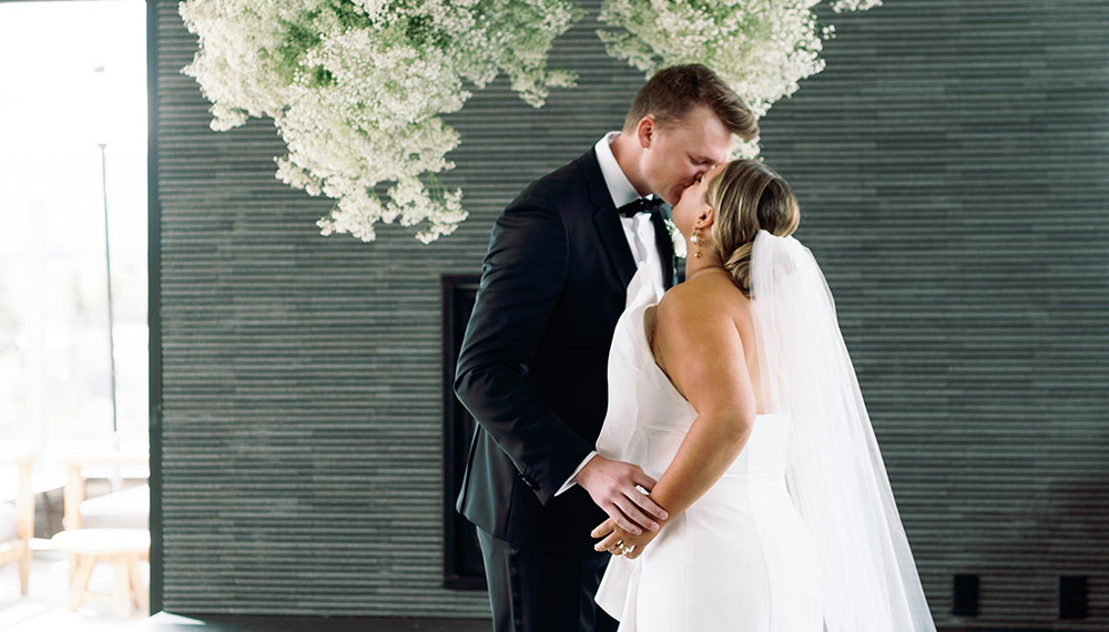 Bride and groom kissing in Sky Shed