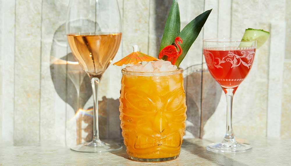 A trio of colorful beverages in cocktail glassware
